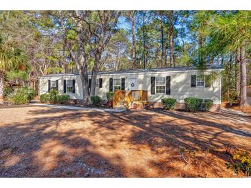 Single-wide manufactured home with wood siding and a spacious yard at 3790 Woodridge Circle, Little River, SC 29566