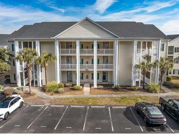 Condo building exterior with parking and landscaping at 5090 Windsor Green Way # 104, Myrtle Beach, SC 29579