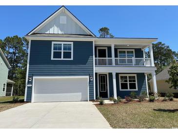 Charming two-story home with a two-car garage, blue siding, and a quaint second story porch at 593 Haven View Way, Murrells Inlet, SC 29576