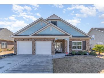 Two-story brick home with two-car garage, and landscaped lawn at 92 Preservation Dr., Myrtle Beach, SC 29572