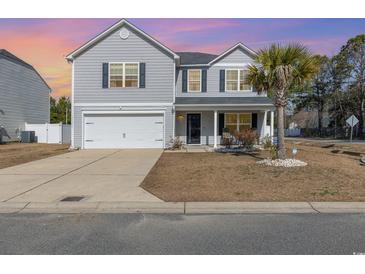 Charming two-story home featuring gray siding, well-kept lawn, and attached two-car garage at 100 Bendick Ct., Little River, SC 29566