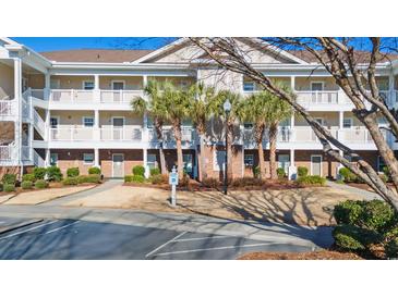 Two-story condo building with balconies and palm trees at 5825 Catalina Dr. # 332, North Myrtle Beach, SC 29582
