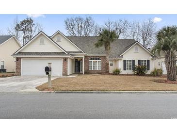 Charming single-story home with a brick facade, a two-car garage, and a well-manicured lawn at 720 Dove Haven Ln., Myrtle Beach, SC 29579