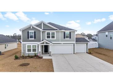 Charming two-story home with gray siding, black shutters, and a three-car garage at 1052 Kinness Dr., Conway, SC 29527