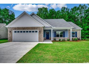 Charming single-story home with brick accents, a manicured lawn, and an attached two-car garage at 106 Riverwatch Dr., Conway, SC 29527