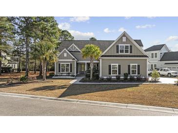 Charming two-story home features a landscaped yard, symmetrical design, and inviting curb appeal at 1196 Fiddlehead Way, Myrtle Beach, SC 29579