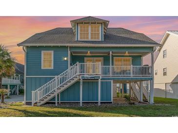 Charming beach house with wrap-around porch and elevated design at 719 N Waccamaw Dr., Murrells Inlet, SC 29576