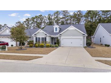 Charming single-story home with manicured lawn and attached two-car garage at 3713 Park Pointe Ave., Little River, SC 29566