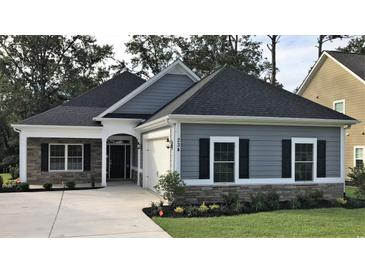 Charming single-story home with gray siding, stone accents, and a well-manicured lawn at 600 Barona Dr., Myrtle Beach, SC 29579