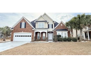 Charming brick two-story home with manicured lawn, attached garage, and classic architectural details at 8304 Parasol Ct., Myrtle Beach, SC 29579