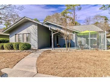 Charming single-story home featuring a well-manicured lawn and inviting walkway at 908 Cedarwood Circle, Myrtle Beach, SC 29572