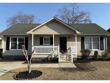 Charming single-story home with a welcoming front porch, black shutters, and landscaped front yard at 9450 Old Palmetto Rd., Murrells Inlet, SC 29576