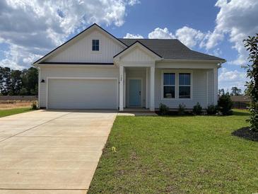 Charming single-story home featuring a tidy front yard and a light blue front door at 148 Joyce Dr, Longs, SC 29568