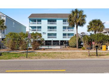 Bright, three-story beach condo with multiple balconies, palm trees, and a black metal fence at 1510 S Ocean Blvd. # 101, Surfside Beach, SC 29575