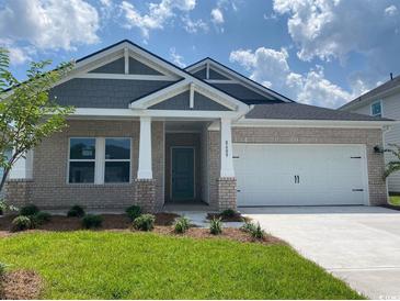 Charming single Gathering home with brick facade, well-manicured lawn, and inviting front porch at 2027 Copper Creek Loop, Longs, SC 29568