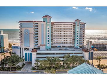 Beautiful light blue and tan exterior of a multi-story beachfront condo building with a parking deck on the lower level at 2301 S Ocean Blvd. # 825, Myrtle Beach, SC 29577