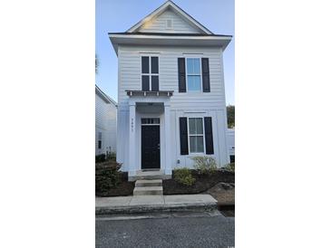Charming two-story home featuring a dark front door, black shutters, and well-maintained landscaping at 3491 Alexandria Ave., Myrtle Beach, SC 29577