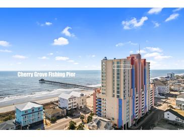 A view of the building and ocean from the exterior, with a fishing pier in the distance at 3601 N Ocean Blvd. # 1840, North Myrtle Beach, SC 29582