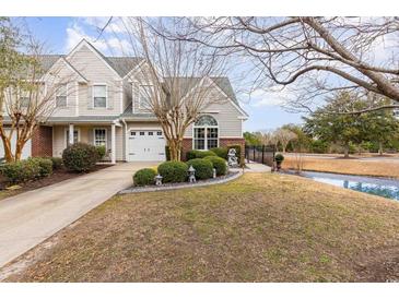 Charming two-story home with an attached garage and a well-manicured lawn with privacy bushes at 1069 Williston Loop # 1069, Murrells Inlet, SC 29576