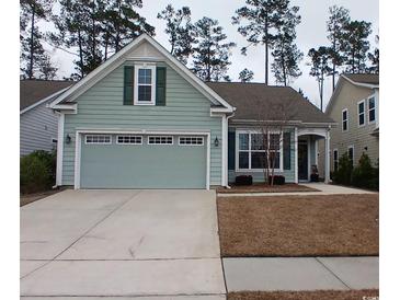 Charming one-story home with a two-car garage, manicured lawn, and light blue siding at 1883 Suncrest Dr., Myrtle Beach, SC 29577