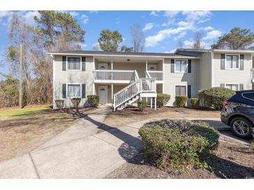 Charming two-story condo building with a white staircase leading to the upper units at 3555 Highway 544 # 17F, Conway, SC 29526