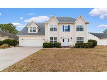 Charming two-story home featuring blue shutters, an attached two-car garage, and a well-maintained lawn at 470 Spring Lake Dr., Myrtle Beach, SC 29579