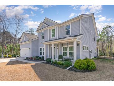 Charming two-story home with a well-manicured lawn and inviting front porch at 818 Mourning Dove Dr., Myrtle Beach, SC 29577