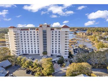 Stunning aerial view of the condo building with manicured landscaping, parking, and waterfront views at 9547 Edgerton Dr. # Ph1005, Myrtle Beach, SC 29572