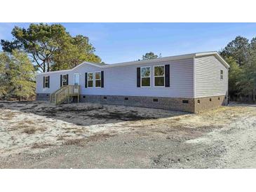 Charming single-story home features gray siding, brick foundation, and black shutters at 1455 Francis Marion Dr., Georgetown, SC 29440