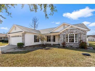 Charming single story home with a brick and white exterior, attached garage, and landscaped front yard at 1021 Dunraven Ct., Conway, SC 29527