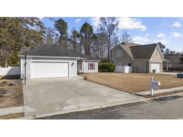 Charming single-story home featuring a two-car garage, well-maintained lawn and classic design elements at 109 Jessica Lakes Dr., Conway, SC 29526