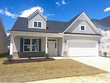 Charming new construction home with gray siding, a two-car garage, and a well-manicured front yard at 1091 Forest Bend Dr., Calabash, NC 28467