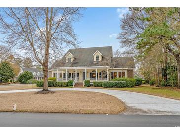 Charming traditional home featuring a welcoming front porch and a circular driveway at 1110 Links Rd., Myrtle Beach, SC 29575