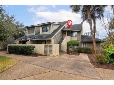 Charming two-story condo features neat landscaping, a private entrance, and mature palm trees at 129 Hartland Dr. # 8-I, Myrtle Beach, SC 29572