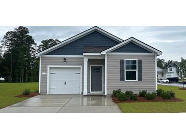 Charming single-story home featuring a one-car garage and neutral colored horizontal siding and dark grey accents at 153 Leyland Cypress Dr, Conway, SC 29527
