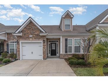 Charming home with stone accents, a one-car garage, and a well-maintained lawn in a desirable community at 156 Parmelee Dr. # B, Murrells Inlet, SC 29576