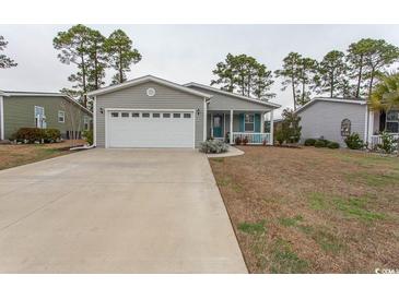 Charming home with a gray exterior, two-car garage, and well-manicured front lawn at 1668 Greenridge Dr., Conway, SC 29526