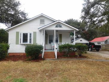 Charming one-story home with a covered front porch, green shutters, and landscaped front yard at 223 Greentown Rd., Georgetown, SC 29440