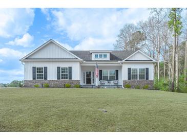 Charming single-story home with a well-manicured lawn, black shutters, and an inviting front porch at 250 Ole Maple St., Loris, SC 29569