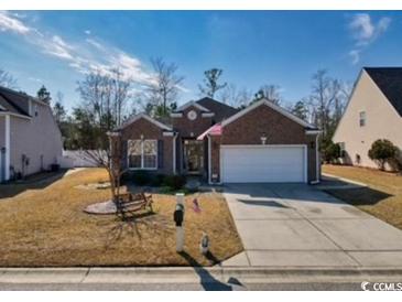 Charming single-story brick home with a well-maintained lawn and two-car garage at 263 Burchwood Ln., Myrtle Beach, SC 29588