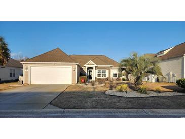 Charming single-story home featuring manicured landscaping, a two-car garage, and a welcoming entrance at 3108 Robins Nest Way, Myrtle Beach, SC 29579