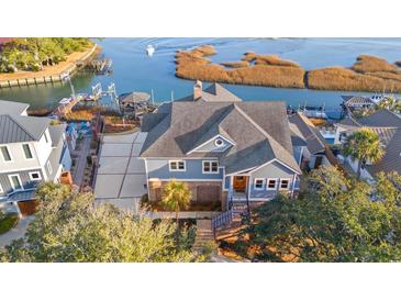 Stunning aerial view of a two-story home with a boat dock and water access at 3567 Marion Ln., Murrells Inlet, SC 29576