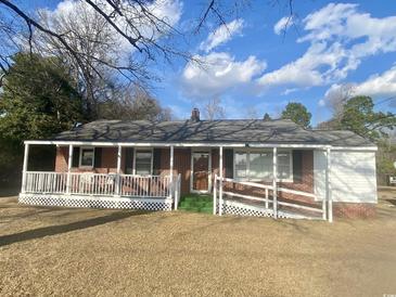 Charming single-story brick home with covered porch and accessible ramp at 611 E Ashland St., Andrews, SC 29510