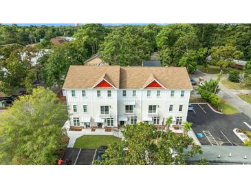 New construction townhomes feature white exteriors, private balconies, and dedicated parking in a desirable location at 6606 Wildwood Trail # D, Myrtle Beach, SC 29572