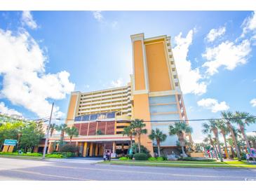 A lovely view of this multi-story resort with palm trees, street view, and bright blue skies at 6900 N Ocean Blvd. # 1536, Myrtle Beach, SC 29572