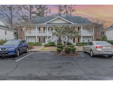 Charming two-story condo with double balconies, manicured landscaping, and convenient parking at 1250 River Oaks Dr. # 16B, Myrtle Beach, SC 29579