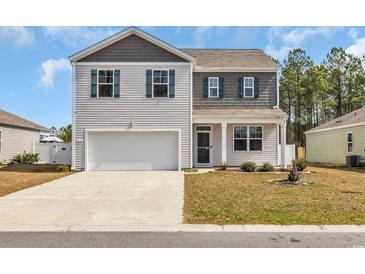 Charming two-story home featuring a two-car garage and a well-maintained lawn on a sunny day at 220 Forestbrook Cove Circle, Myrtle Beach, SC 29588