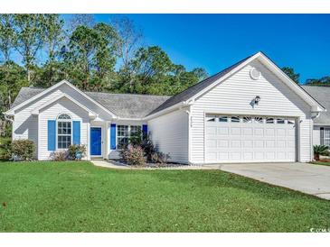 Charming single-story home with white siding, blue shutters, well-maintained lawn, and an attached two-car garage at 2509 Oriole Dr., Murrells Inlet, SC 29576