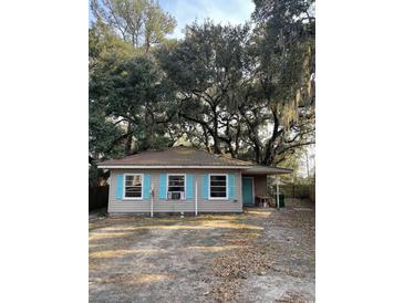 Charming single-story home with turquoise shutters and mature trees with spanish moss at 335 Bayview Dr., Georgetown, SC 29440