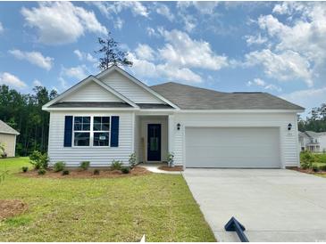 Charming single-story home featuring white siding, blue shutters, and a two-car attached garage at 395 Clear Lake Dr., Conway, SC 29526